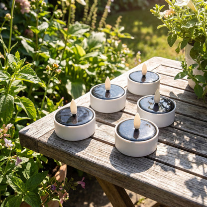 Solar LED tea light candles charging in daylight with solar panels facing the sun, Kiyo Home