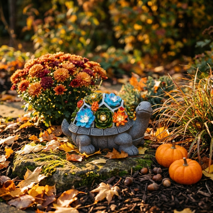 Solar turtle garden light glowing in autumn garden at dusk