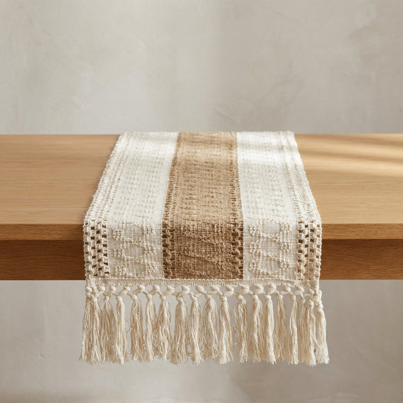 Textured table runner with fringes on a wooden surface