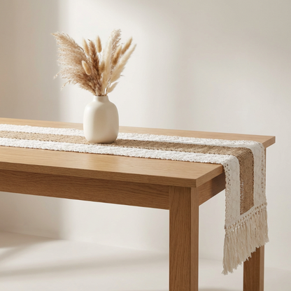 Wooden table with a white vase containing dried pampas grass on a neutral background