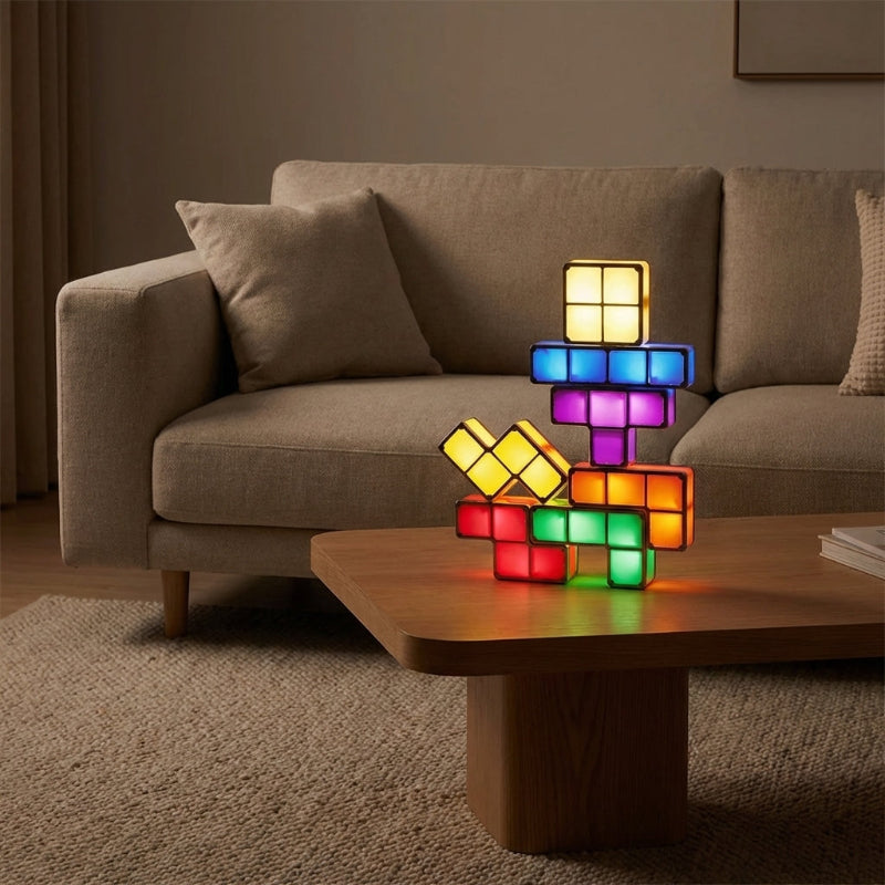 Colorful block-style lamp on a wooden coffee table in a living room setting.