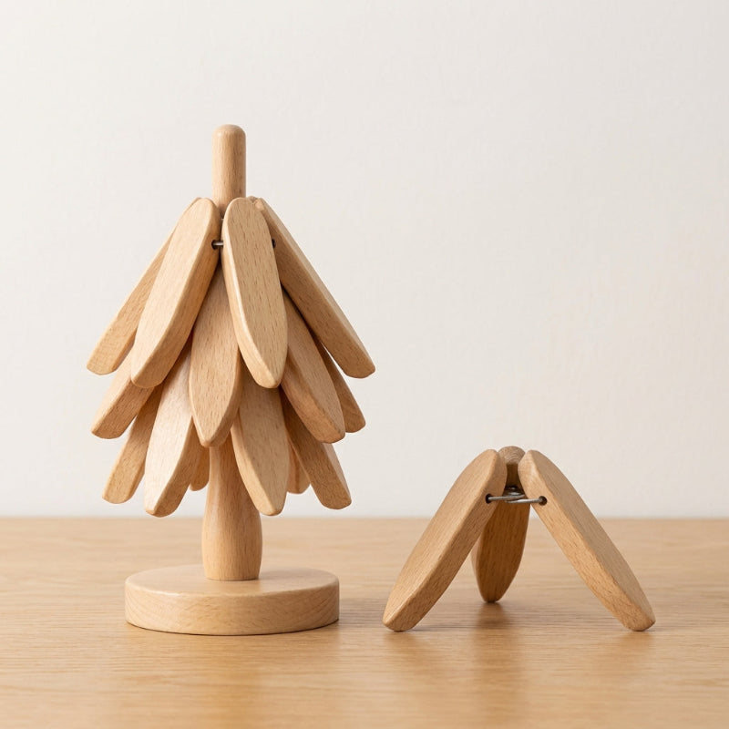 Wooden tree-shaped object on a wooden surface with a plain background