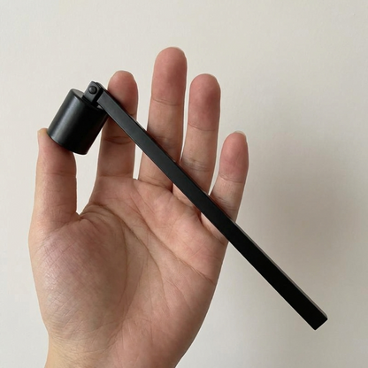 Black stainless steel candle snuffer shown in hand