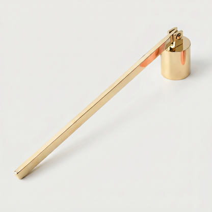Gold stainless steel candle snuffer on white background