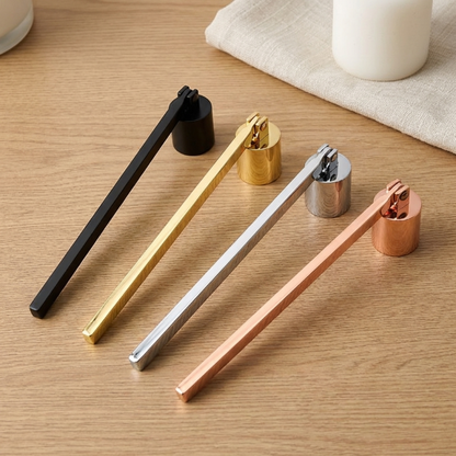 Stainless steel candle snuffers in black, gold, silver, and copper on wood surface