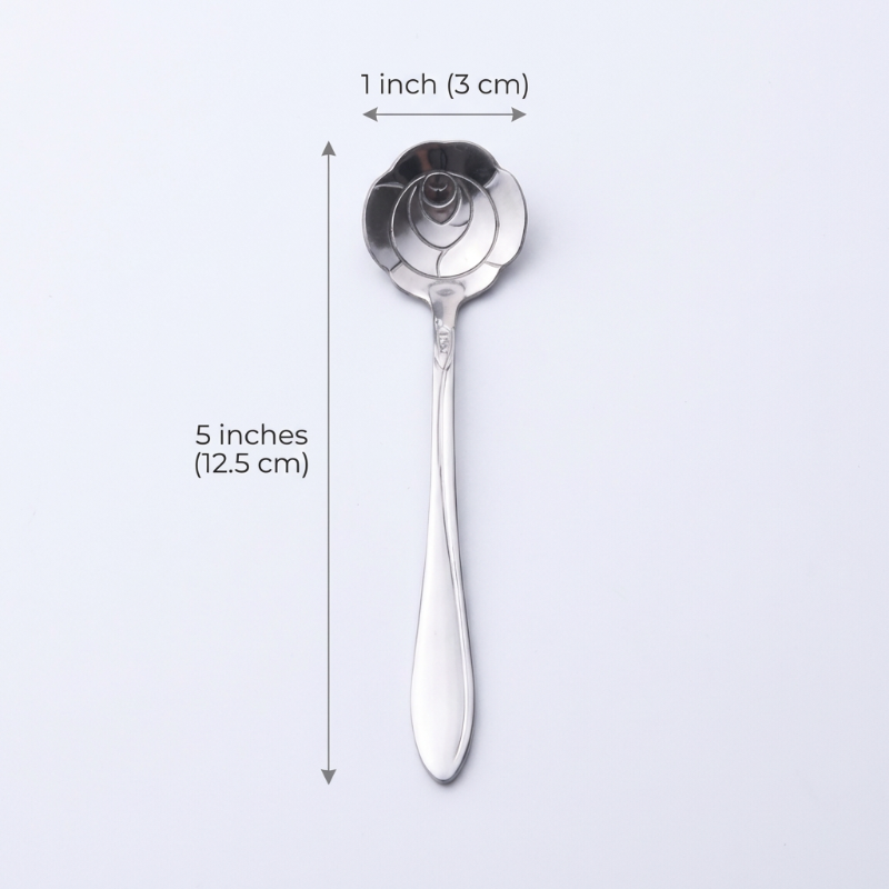 Silver spoon with measurements on a light gray background