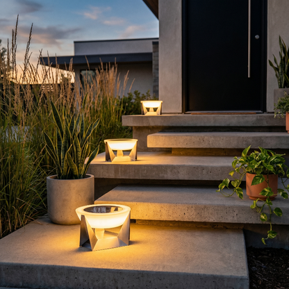 Stainless steel solar lamp on patio steps in a landscaped yard