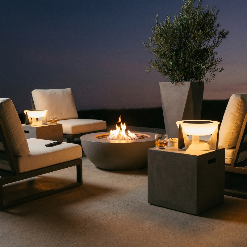 Stainless steel solar lamps on patio beside outdoor seating in warm evening setting