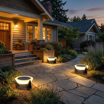 Evening view of a house exterior with stone pathway and outdoor lighting.