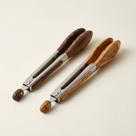 Two pairs of wooden-handled tongs on a beige background
