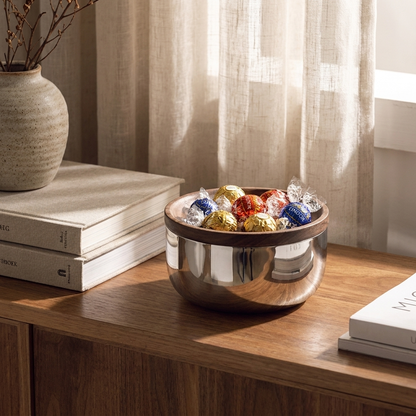 Stainless steel walnut-lid bowl with wrapped treats on a shelf with books, Kiyo Home