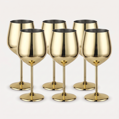 Set of six gold stainless steel stemmed wine glasses with a mirror-polished finish on a clean off-white background
