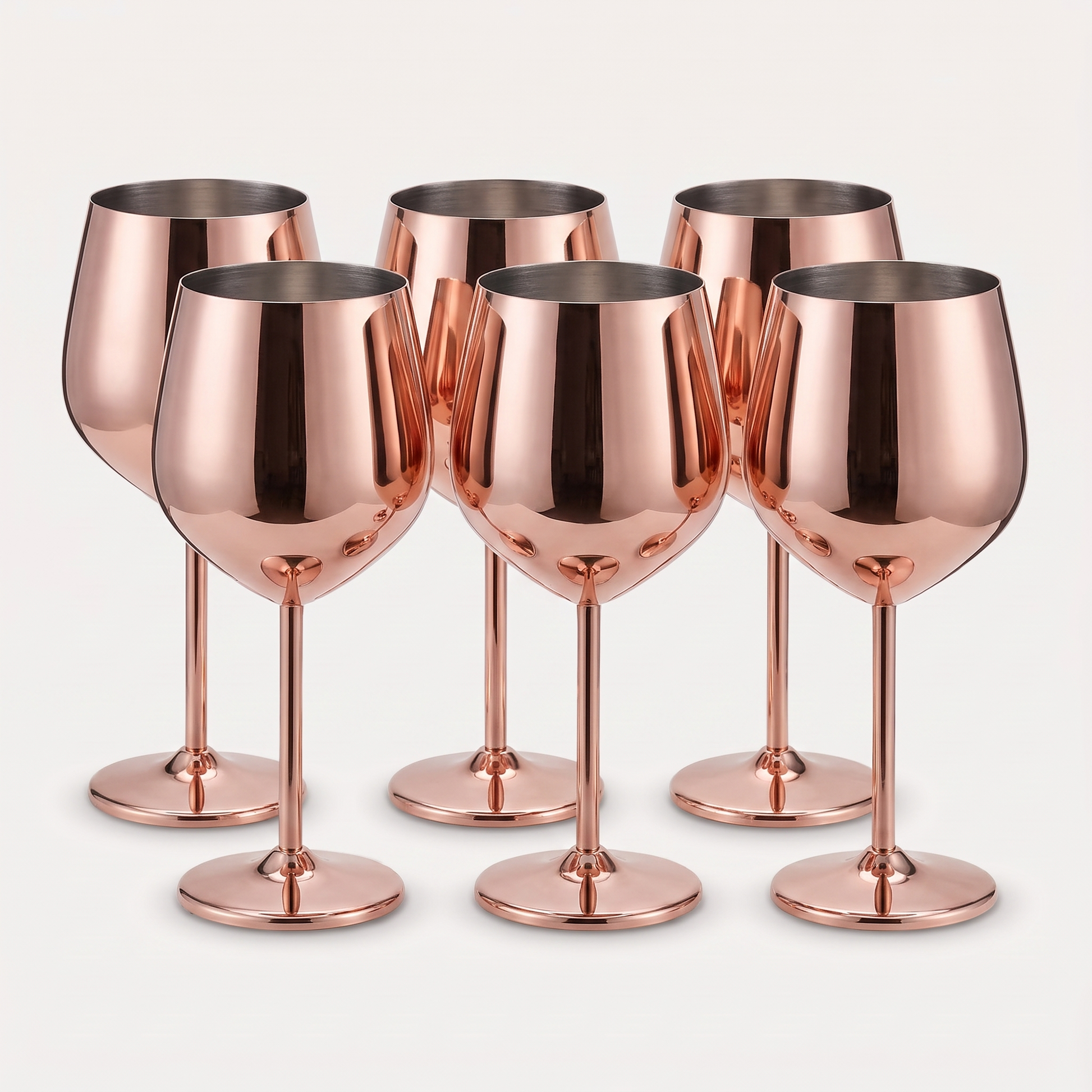 Set of six rose gold stainless steel stemmed wine glasses with a mirror-polished finish on a clean off-white background