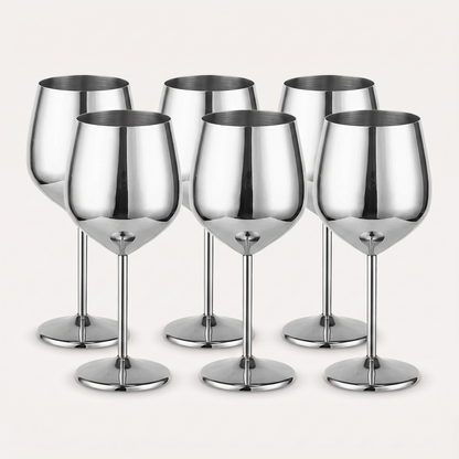 Set of six silver stainless steel stemmed wine glasses with a mirror-polished finish on a clean off-white background