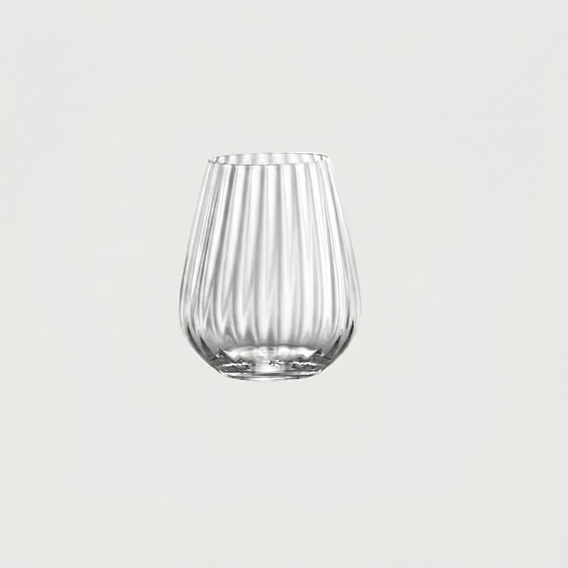 Clear glass tumbler with vertical ribbing on a light gray background