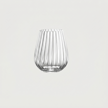 Clear glass tumbler with vertical ribbing on a light gray background