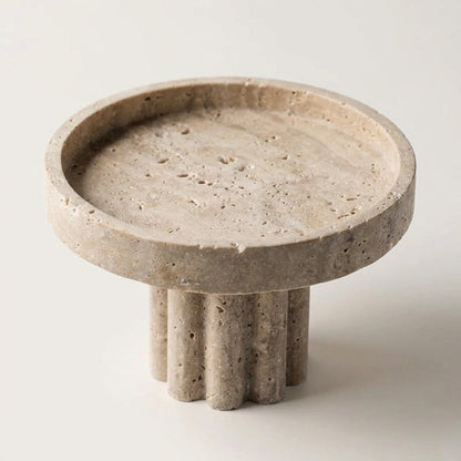 Concrete trivet with three cylindrical legs on a light background