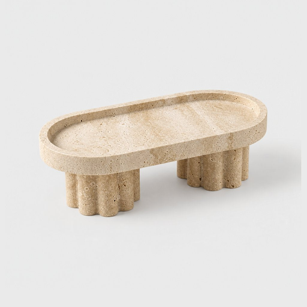 Empty oval pale beige pedestal tray with a low rim on two fluted legs, on a plain light gray background