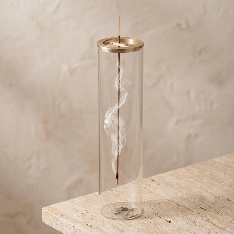 Suspended glass incense burner on modern desk