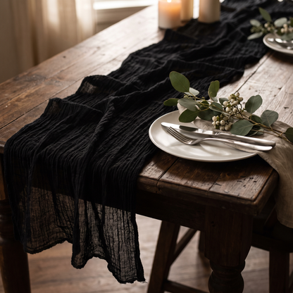 Black gauze table runner with eucalyptus on a dark dining table, Kiyo Home 71-inch table runner