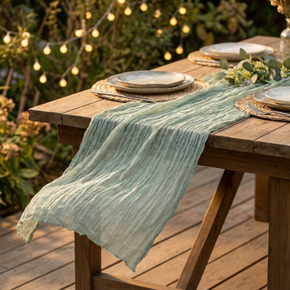 Sage green gauze table runner on an outdoor patio table with string lights, Kiyo Home 71-inch table runner
