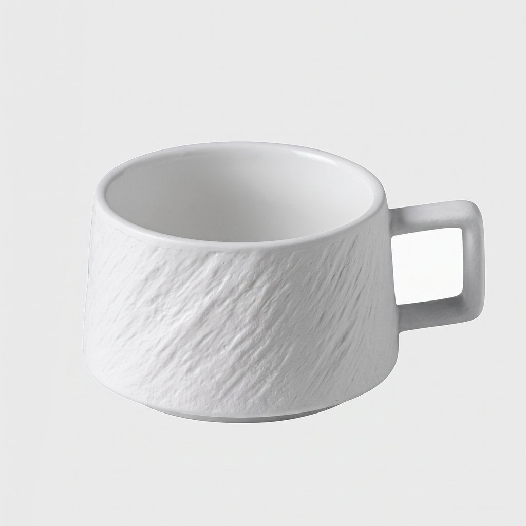 White textured ceramic cup on a plain light background