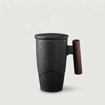 Thermal mug with wood handle pouring tea into cup