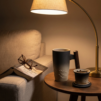 Thermal mug with wood handle on bedside table with lamp