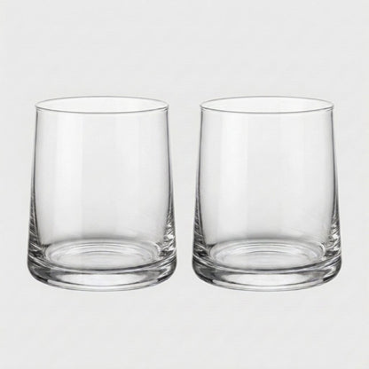Set of two clear drinking glasses side by side on a light gray background