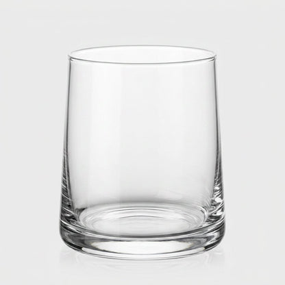 Single clear drinking glass on a light gray background