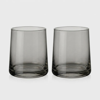 Set of two smoke gray translucent drinking glasses side by side on a light gray background