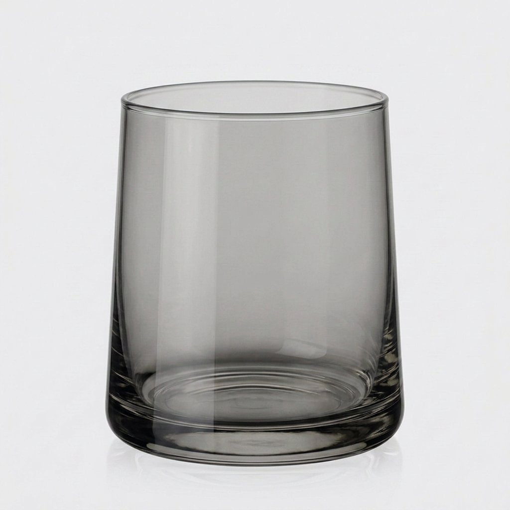 Single smoke gray translucent drinking glass on a light gray background