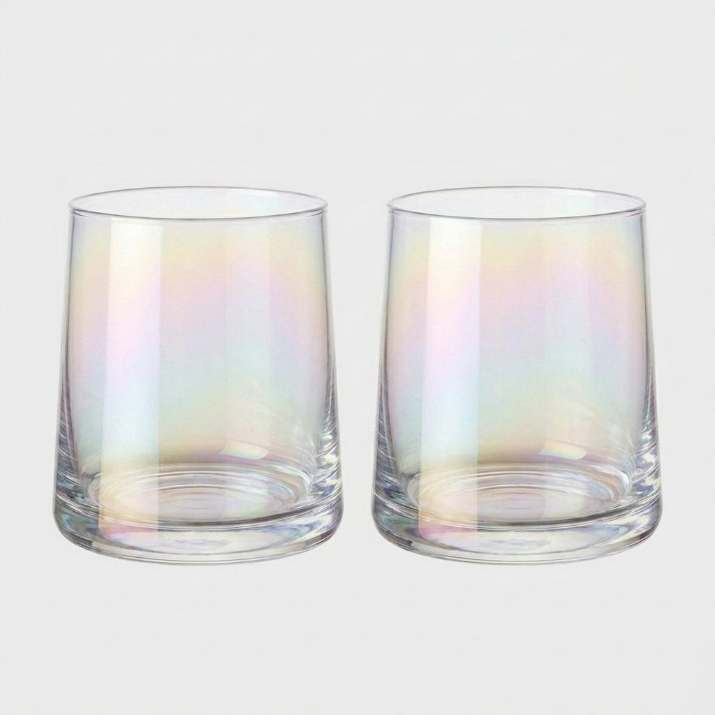 Set of two iridescent drinking glasses with a soft rainbow sheen side by side on a light gray background