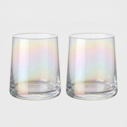 Set of two iridescent drinking glasses with a soft rainbow sheen side by side on a light gray background