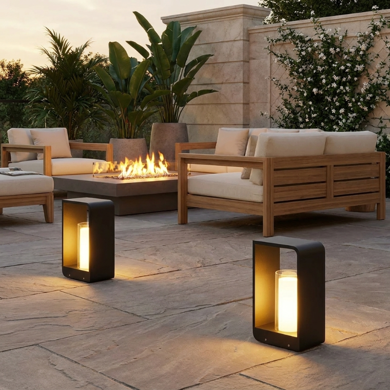 Twilight outdoor solar lanterns on patio beside outdoor sofa in warm evening light