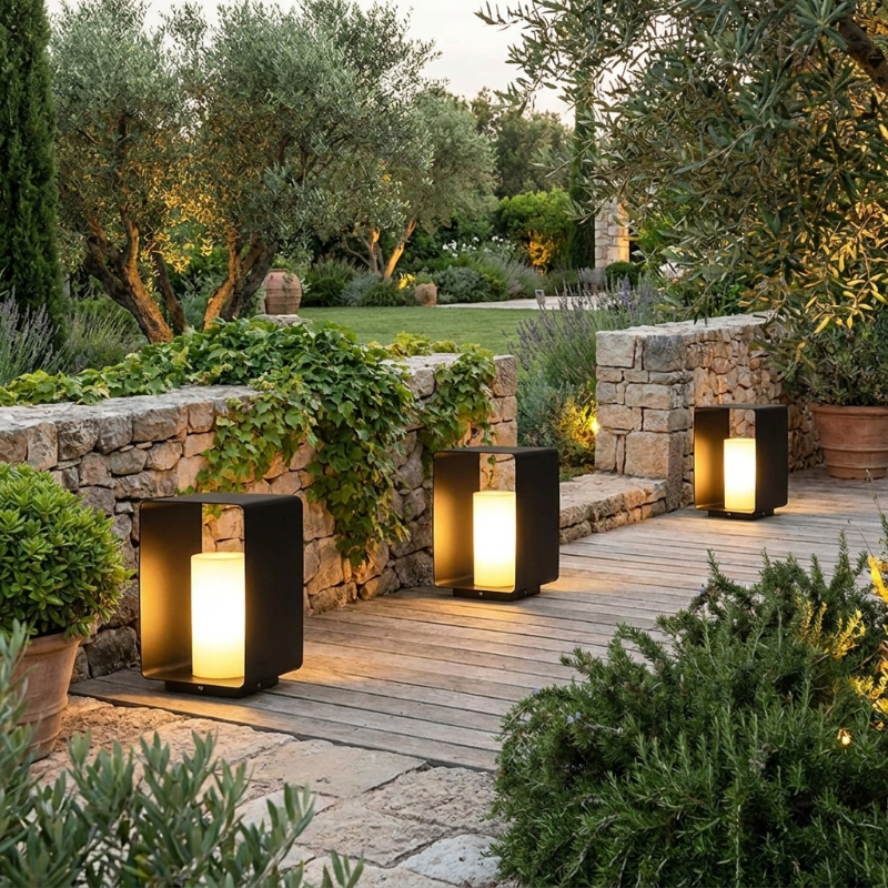Twilight outdoor solar lanterns on stone patio in landscaped garden