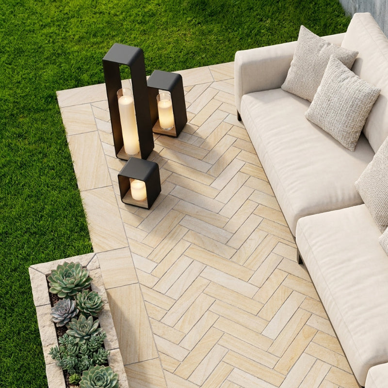 Twilight outdoor solar lantern on patio beside outdoor sofa cushion
