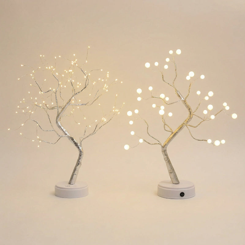 Two LED tree lights with white base on a beige background