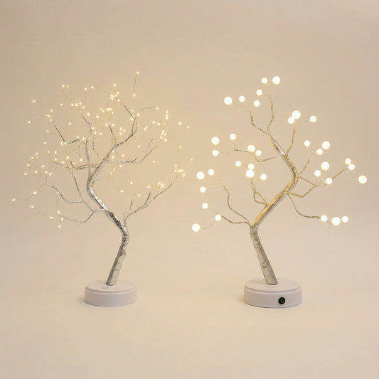 Two LED tree lights with white base on a beige background