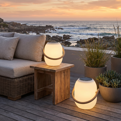 SunLume outdoor solar lantern on outdoor side table by ocean view