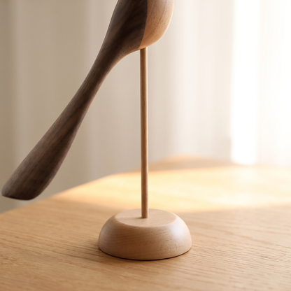Two-Tone Wood Bird Sculpture close-up detail of the light wood round base and thin dowel