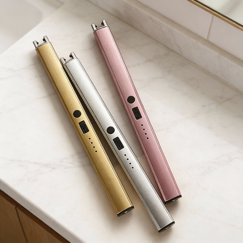 Three electronic devices in gold, silver, and pink on a light surface.