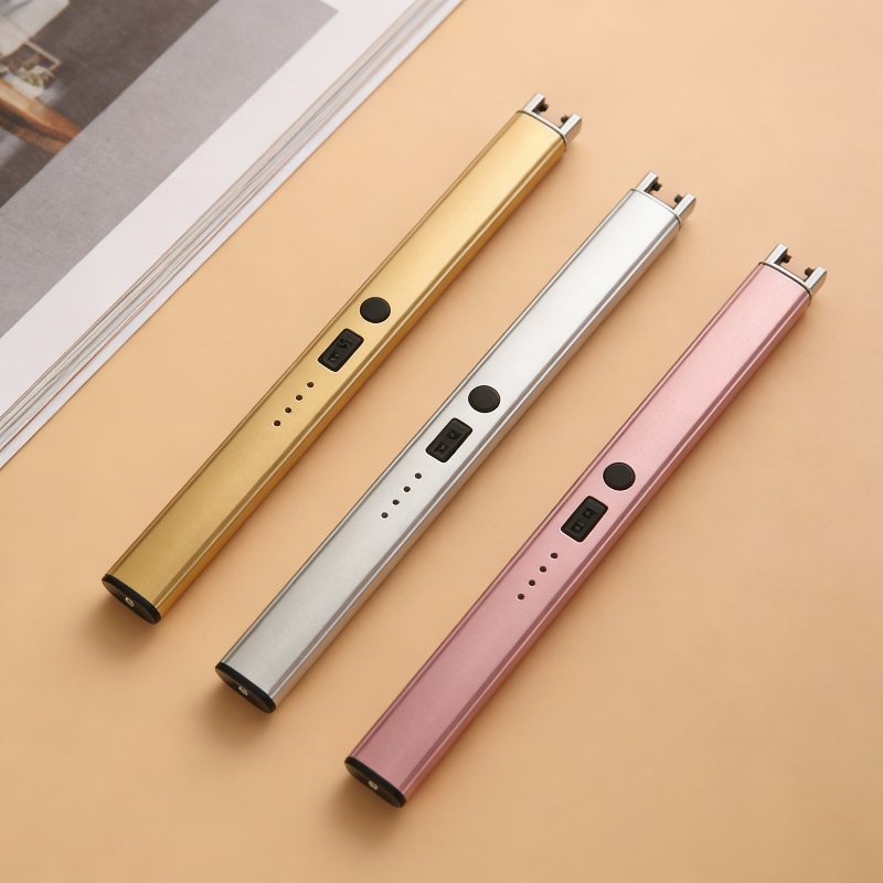 Three electronic devices in gold, silver, and pink on a beige surface.