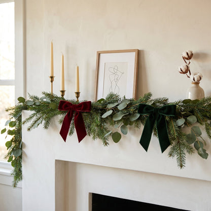 Velvet bows decorating holiday mantel greenery