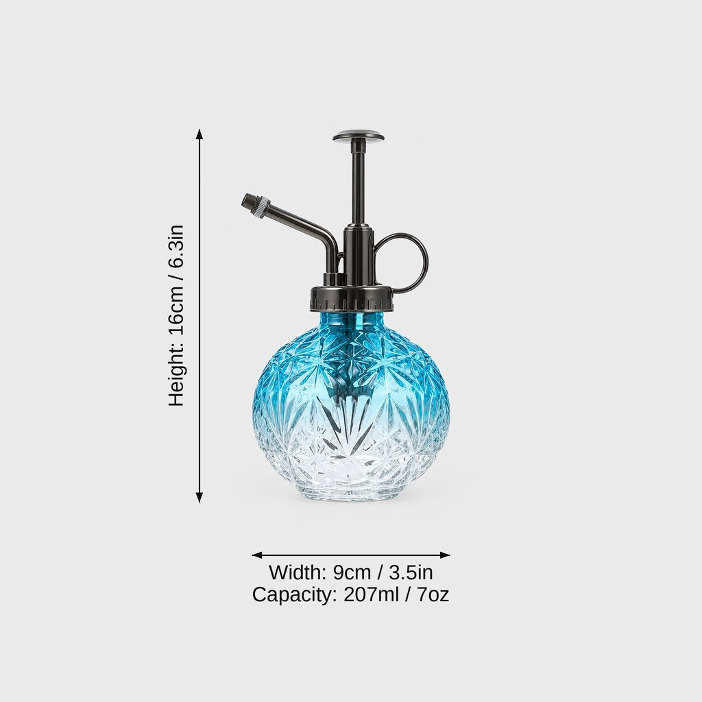 Blue ombre cut glass plant mister with dark metal pump top on a light grey background with dimensions labeled Height 16 cm or 6.3 in, Width 9 cm or 3.5 in and Capacity 207 ml or 7 oz