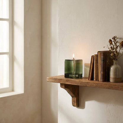 Vintage green glass oil lamp on shelf