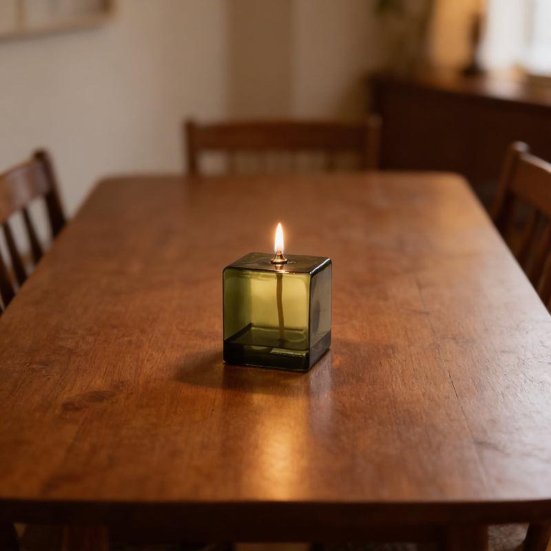 Vintage green glass oil lamp on dining table