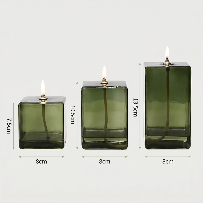 Three green glass candle holders with dimensions on a white background