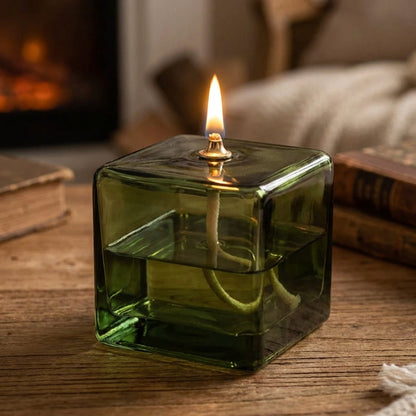 Soft warm flame inside green square glass oil lamp