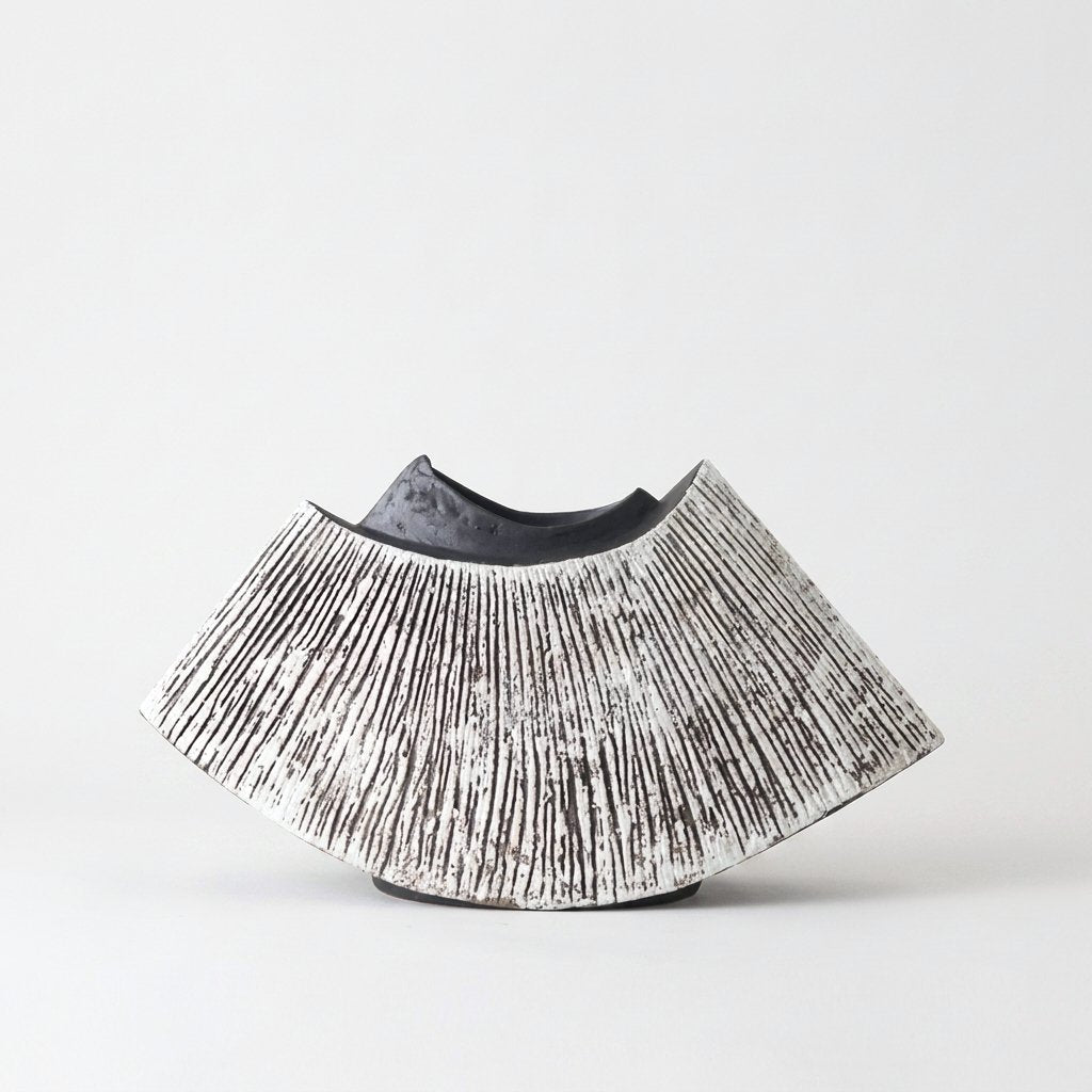Black and white WabiSabi Ceramic Vase with a textured ridged exterior and fan-shaped silhouette, hero shot on a clean off-white background